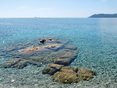 a group of rocks in the water on a beach at B&B DomuSanna in Villaputzu