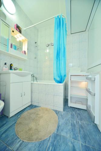 a white bathroom with a tub and a sink at Split Center Room Helena in Split