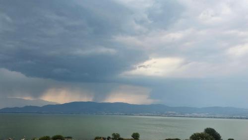 a rainbow in the sky over a body of water at Lake Dream 1 in Sretenovo