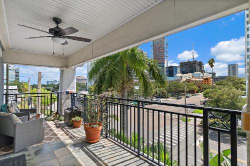 a balcony with a ceiling fan and a view of a city at Walk to Everything Downtown EAT - SHOP - PLAY in St. Petersburg