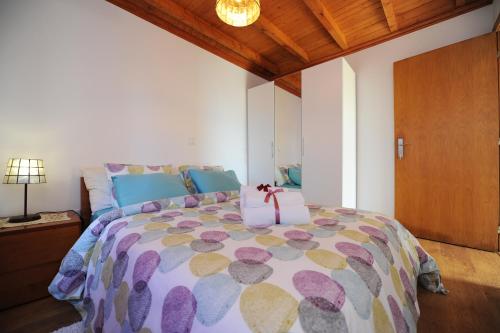 a bedroom with a large bed with a bow on it at BHF Residences Bordadeira in Arco da Calheta