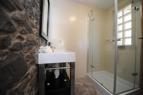 a bathroom with a sink and a shower at BHF Residences Bordadeira in Arco da Calheta