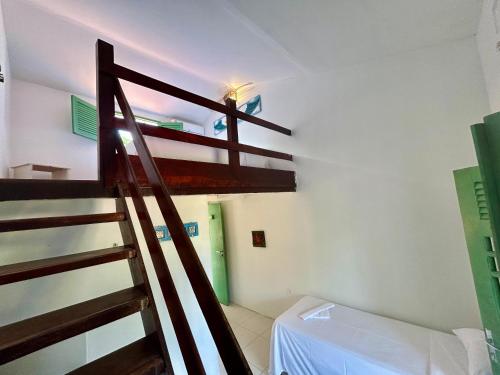 a room with a bunk bed and a ladder at Pousada Maracaju in Porto De Galinhas