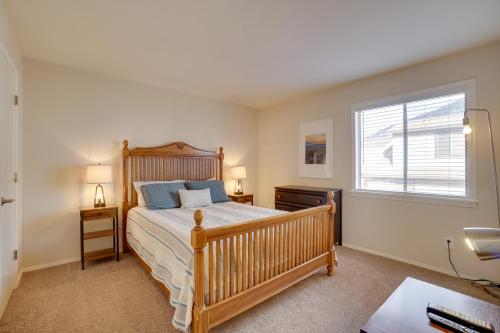 a bedroom with a wooden bed and a window at Flagstaff Townhome with Grill about 3 Mi to Downtown! in Flagstaff