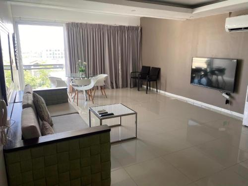 a living room with a couch and a table at Chequers Suites Subic Bay in Olongapo