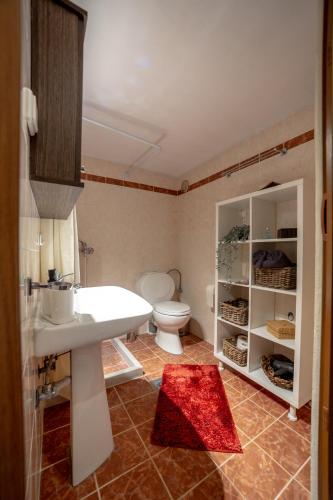 a bathroom with a white sink and a toilet at Catch n relax in Kalabaka