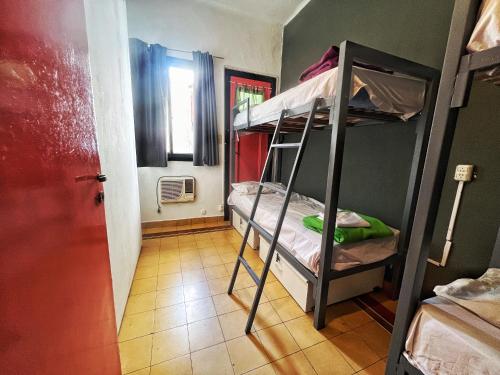 a room with two bunk beds in a room at Lacandona Hostel in Cordoba
