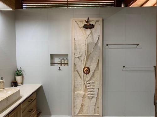 a shower with a glass door in a bathroom at Kubu Shanti in Gili Meno