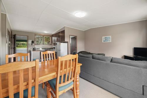 a living room with a couch and a table at Mahoe Motel in Taumarunui