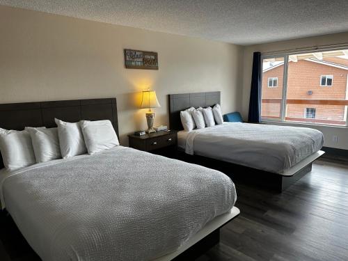 a hotel room with two beds and a window at Inn at the Sea in Long Beach
