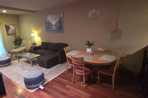 a living room with a table and a couch at Vibrant Living in Harmony, unit C in Seattle