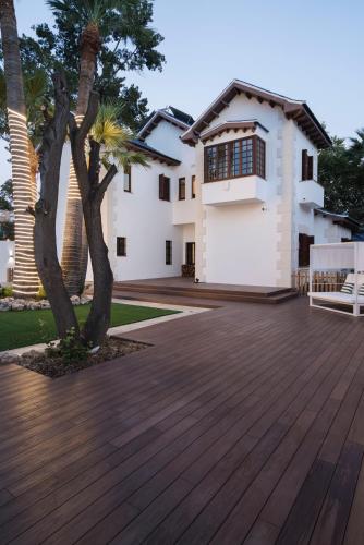a wooden deck in front of a house at La Moderna Suites in Málaga