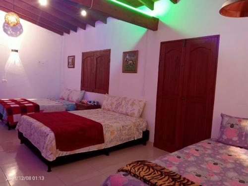 a bedroom with two beds and a couch at Los Tulipanes in Jardin