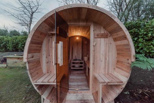 a wooden hobbit house with a circular entrance at Expansive Luxury Country Escape in Prebbleton