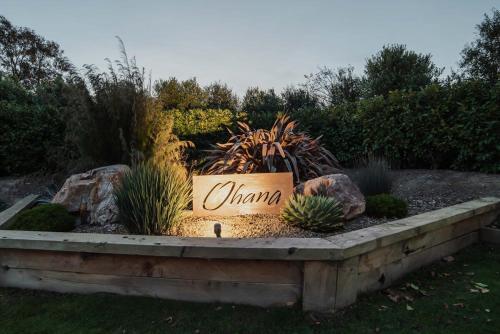 a sign that saysylan in a garden with plants at Expansive Luxury Country Escape in Prebbleton
