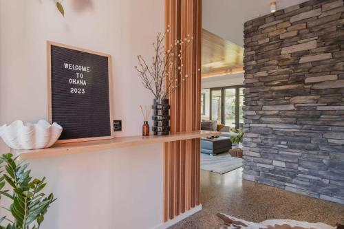 a living room with a stone wall at Expansive Luxury Country Escape in Prebbleton