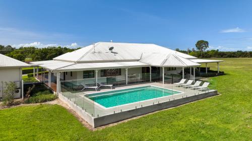 an aerial view of a house with a swimming pool at The Hampton Lodge with private pool on 25 acres in Port Douglas