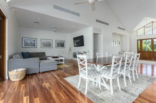 a living room with a table and chairs and a couch at The Hampton Lodge with private pool on 25 acres in Port Douglas
