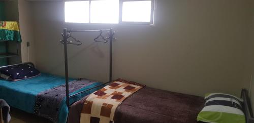Ένα ή περισσότερα κρεβάτια σε δωμάτιο στο Expresso Hostel