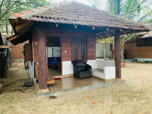 a small house with a couch in front of it at Shim Beach Resort in Arugam Bay