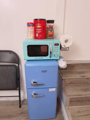 un microondas sobre una nevera en private & Quiet unit D Bed & bath, en Rosemead