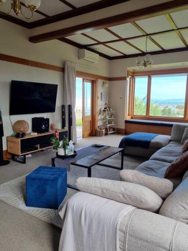 a living room with couches and a flat screen tv at Views on the Terrace in Napier