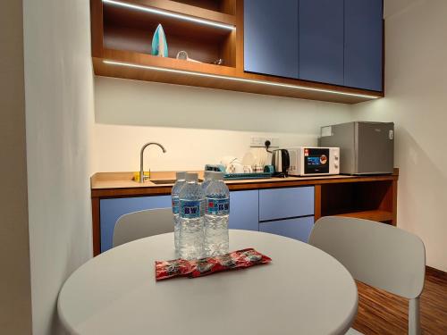 a table with two water bottles on top of it at Near Airport K Avenue Family Room in Donggongon