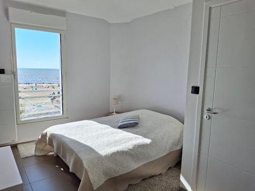 une chambre blanche avec un lit et une fenêtre dans l'établissement Châtelaillon-Plage: Appartement 4 pièces, 6 pers, terrasse, WIFI - FR-1-706-11, à Châtelaillon-Plage