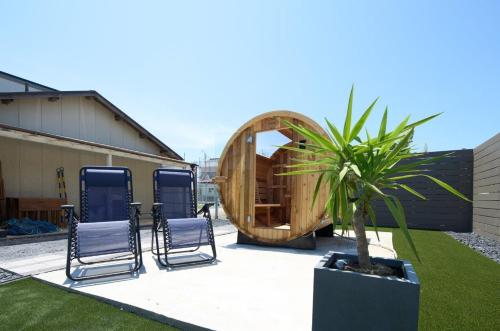 a group of chairs and a sauna in a yard at Sea Saw in Isumi