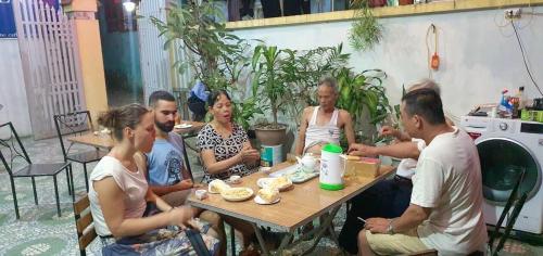 a group of people sitting at a table at Cat Ba Mystery Homestay in Cat Ba