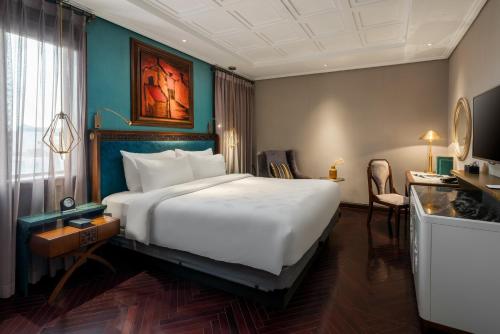 a bedroom with a large white bed in a room at Peridot Grand Luxury Boutique Hotel in Hanoi