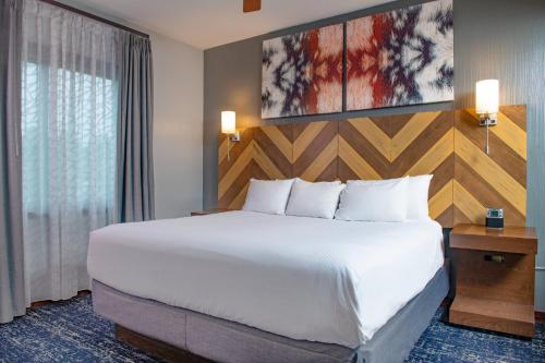 a hotel room with a large bed and a window at Club Wyndham Glacier Canyon in Lake Delton