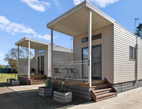 a modular home with a porch and a deck at Shepparton Holiday Park and Village in Shepparton