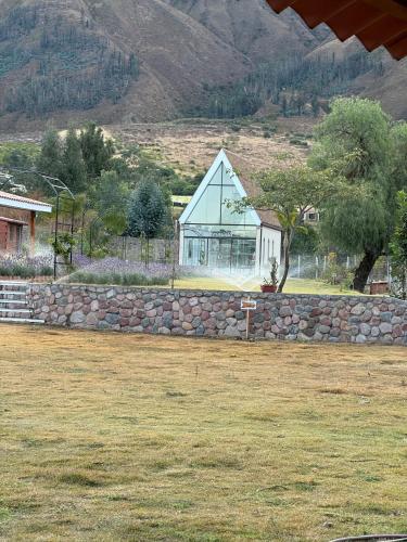 a house on top of a stone wall at Hotel Boutique La Caballeriza in Quillacollo
