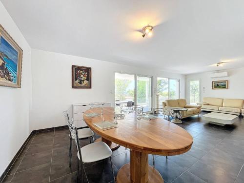 un salon avec une table et des chaises en bois dans l'établissement Villa climatisée avec terrasse, parking et WiFi - Animaux admis à La Cadière-d'Azur - FR-1-770-38, à Laouque