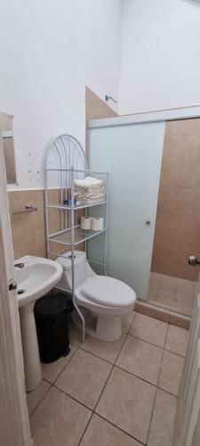 a bathroom with a toilet and a sink at Casa en Residencial MEGAPOLIS, San Miguel in San Miguel