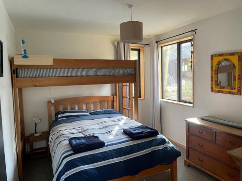 a bedroom with a bed with blue pillows on it at Number 8 - Castle Hill Village in Castle Hill