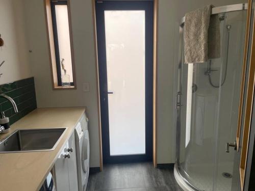 a kitchen with a shower and a sink and a sink at Number 8 - Castle Hill Village in Castle Hill