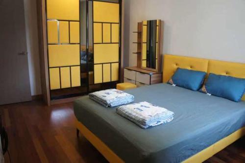 a bed with two pillows on it in a room at Tranquil lake view retreat 思湖茶屋 in Ipoh