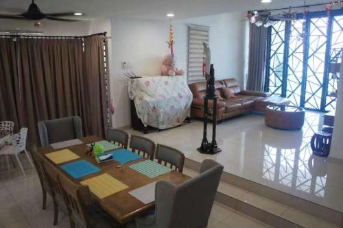 a living room with a table and a couch at Tranquil lake view retreat 思湖茶屋 in Ipoh