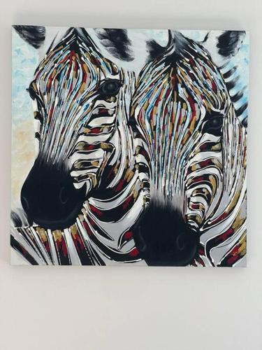 a painting of two zebras standing next to each other at Bach At 45 in Ahipara