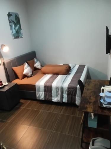 a bedroom with a bed in a room at 24StaycationHome in Kejayan