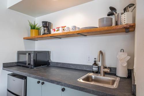 a kitchen counter with a sink and a microwave at Casitas at Capitol Reef in Torrey