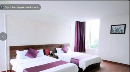 a hotel room with two beds and a window at Phúc Lộc Hotel Ninh Bình in Ninh Binh