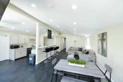 a kitchen and living room with a table and a couch at Sunny San Diego, Entire home, Pool, Free Parking, BBQ, Pets allowed, family neighborhood! in San Diego