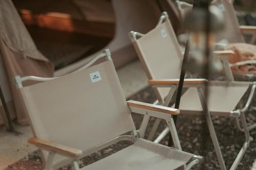 a couple of chairs sitting next to a table at Campgrounds at Mantalongon in Dalaguete