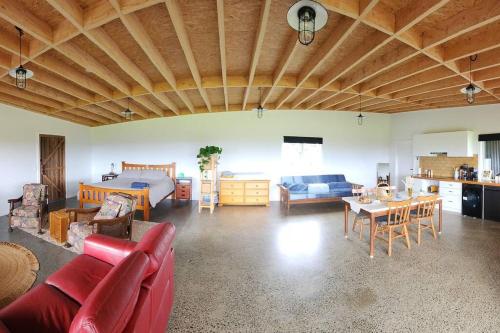 a large living room with a couch and a table at The Shedio On Saddleback in Kiama