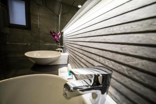 a bathroom with a sink and a bath tub and a sink at Urban Central Suites - Beirut in Beirut