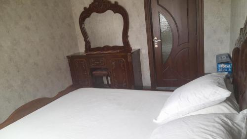 a bedroom with a bed with a dresser and a mirror at Квартира Комфорт in Samarkand