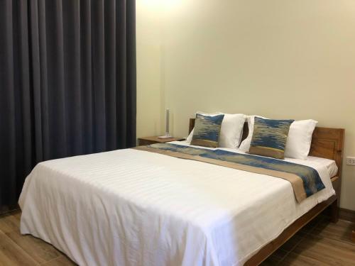 Postel nebo postele na pokoji v ubytování Hoàng Đô Hotel